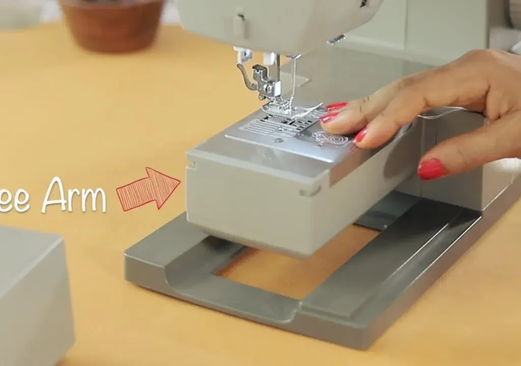 Sewing machine free arm exposed after removing the flatbed extension for stitching cuffs and sleeves.