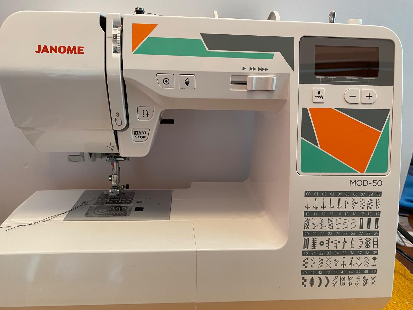 Image of the Janome Mod-50 computerized sewing machine, showing its clean design and LCD screen.